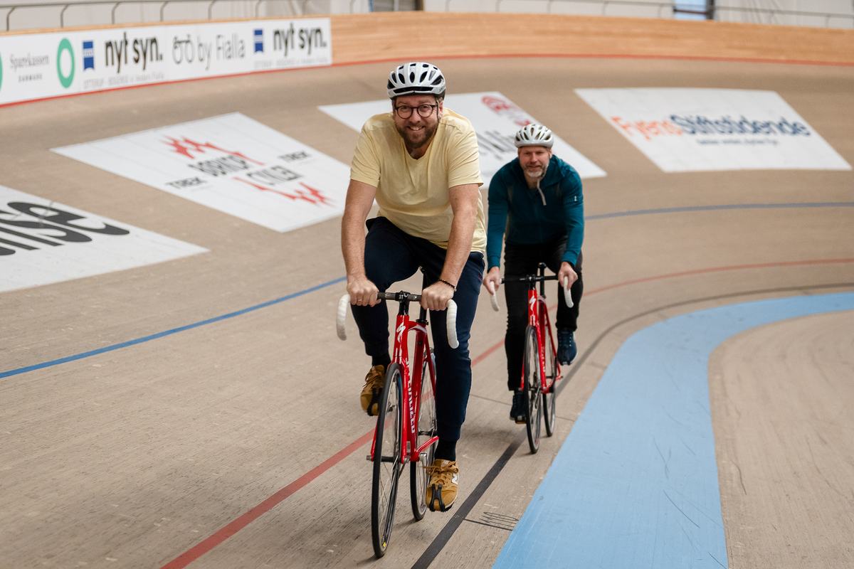 To medlemmer cykler på velodromen
