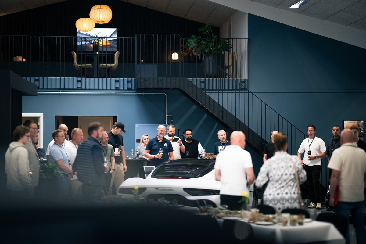 Medlemmer samlet i et bilshowroom
